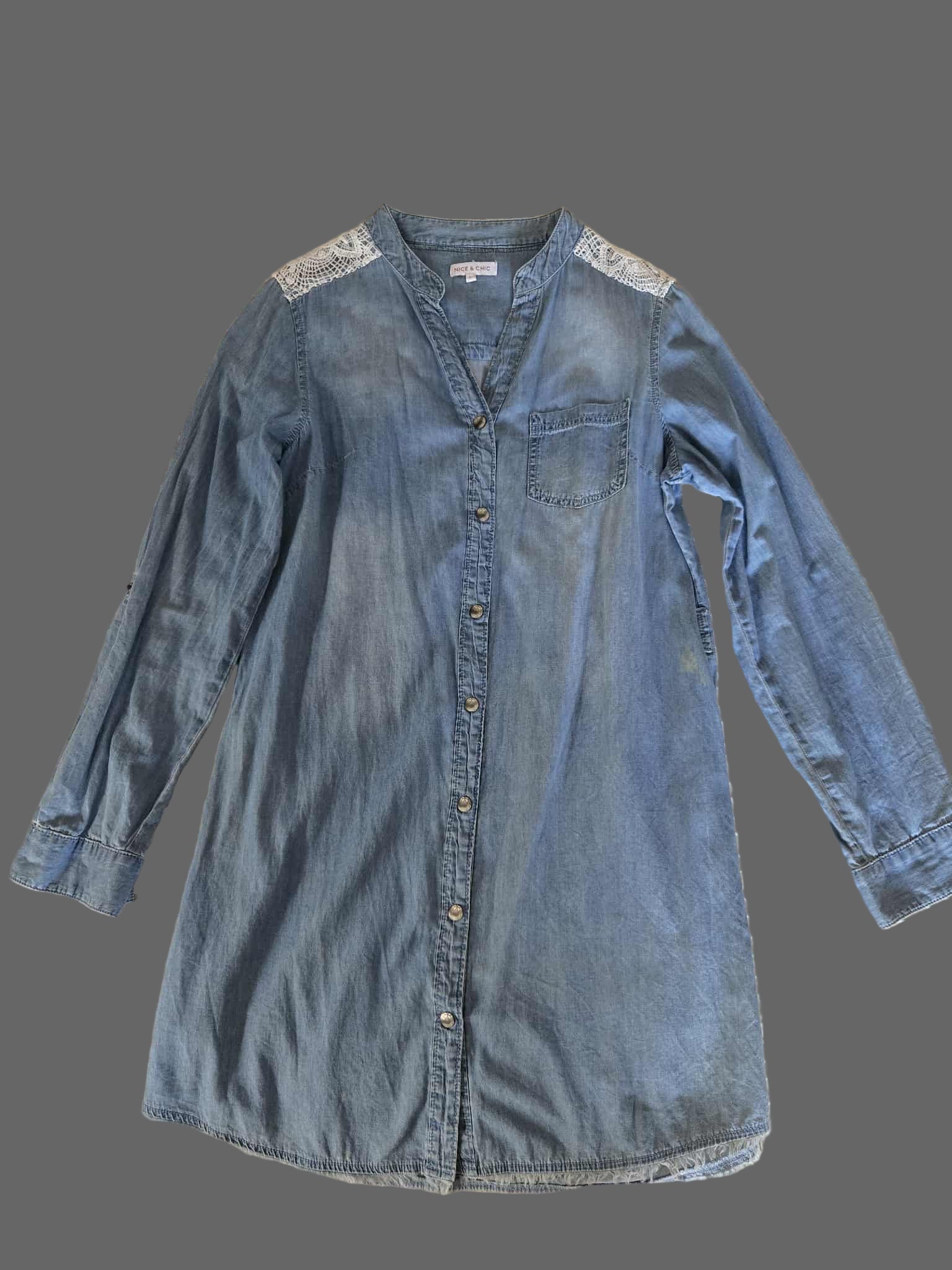 Blue denim dress with lace details on a textured surface